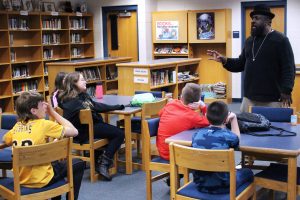 Wheeling YWCA Cultural Diversity and Community Outreach Director Ron Scott speaks to 6th graders in the Moundsville Middle School Library.