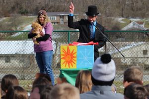 From left: WLES Speech Therapist Becky Hinerman holds Wildcat Wally as WLES PE teacher Michael Grimm exclaims the furry prognosticator says “six more weeks of winter.” Students were excited to hear there is a chance for a few more snow days.