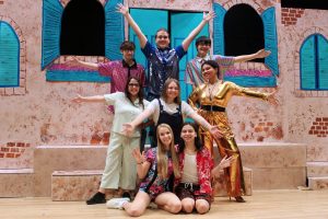 Pictured are cast members of Monarch Company’s production of “Mamma Mia!” Kneeling from left: Sophie (Sydney Hess) and Sky (Jacob Boyette). Middle row: Rosie (Amelia Kaste), Donna (Khloe Trussell) and Tanya (Angestura Kash). Back row: Bill (Tyler Hiestand), Sam (Issac Perry) and Harry (Kal-el Hill).