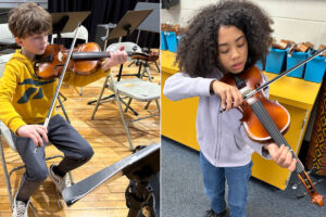 Pictured from left: Central Elementary student Hunter Stierwald and Center McMechen Elementary student Tahiri Mason rehearse for the upcoming concert at their schools.