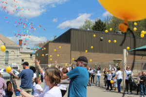 Balloons and confetti are in the air above the Center McMechen Elementary playground.