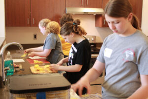 Students learning how to make food while attending CTE Camp