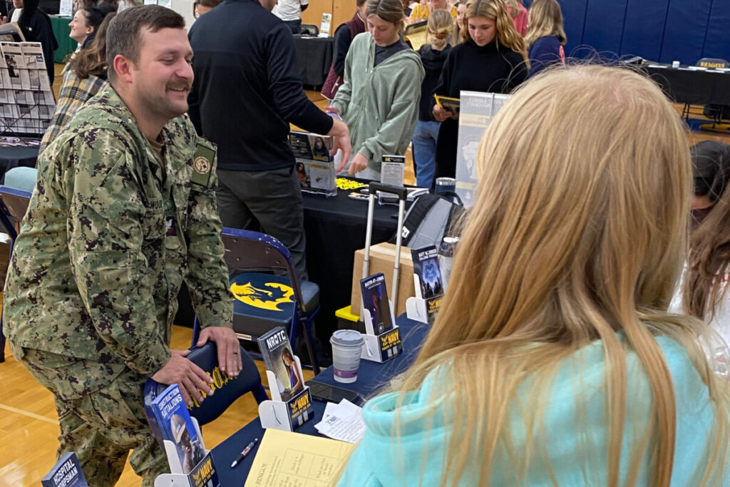 Students talk to a Navy representative. 